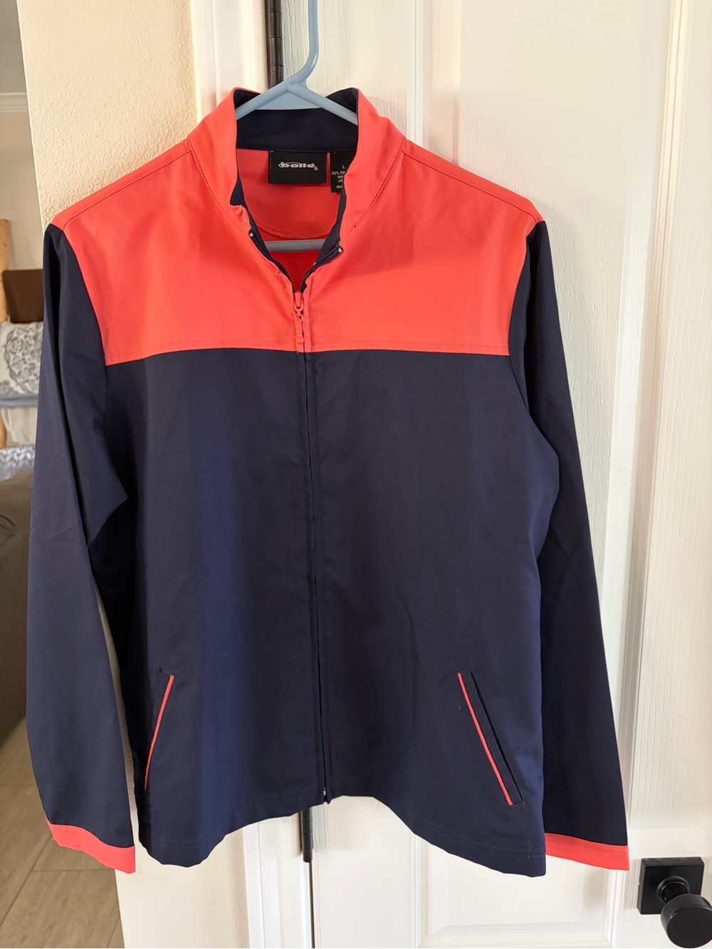 Women’s Navy and Coral windbreaker. Size Large